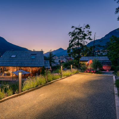 Espace vert devant un beau chalet à Serre-chevalier, pelouse, arbres et massifs mis en place par nos jardiniers paysagistes
